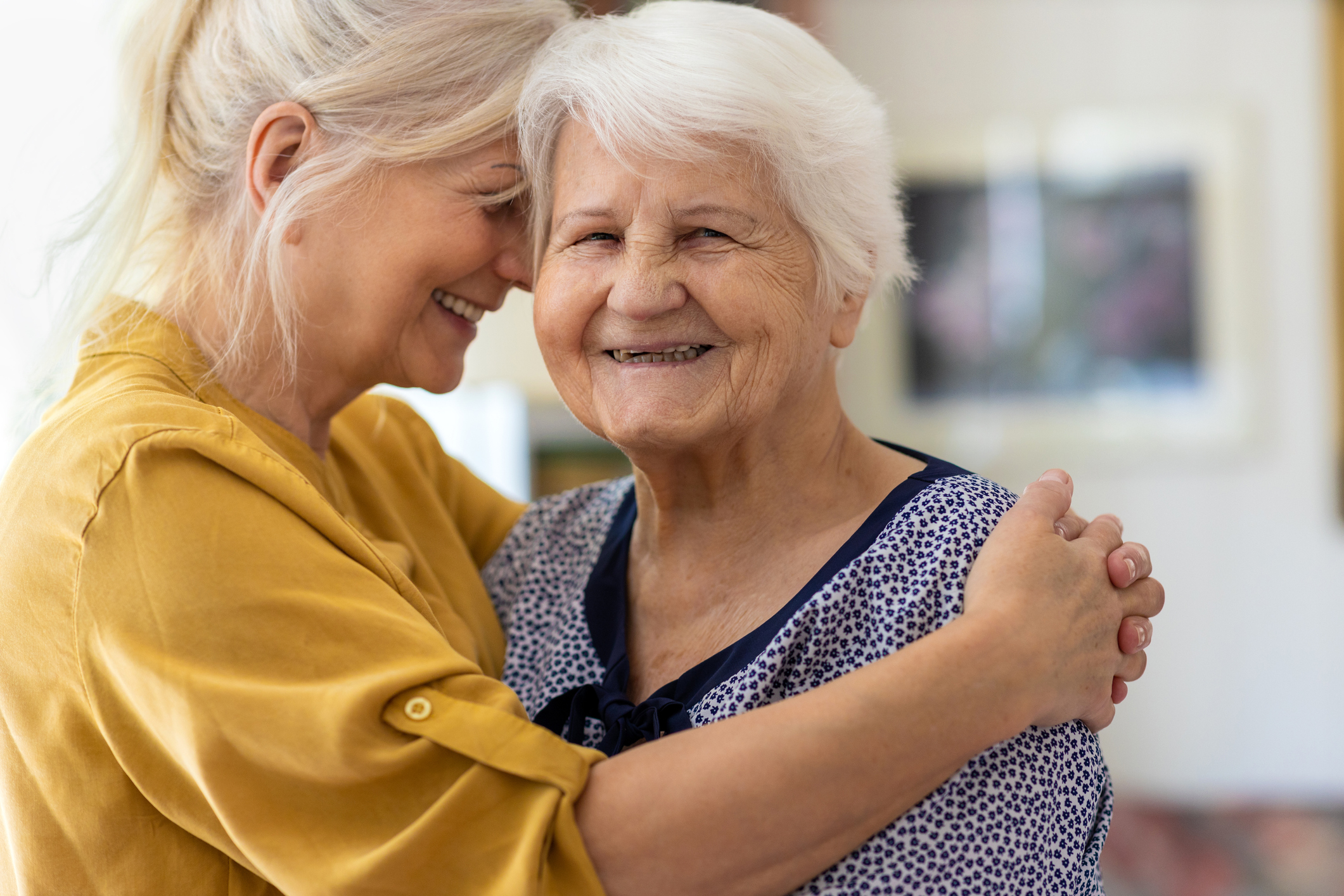 Woman embracing her elderly mother
